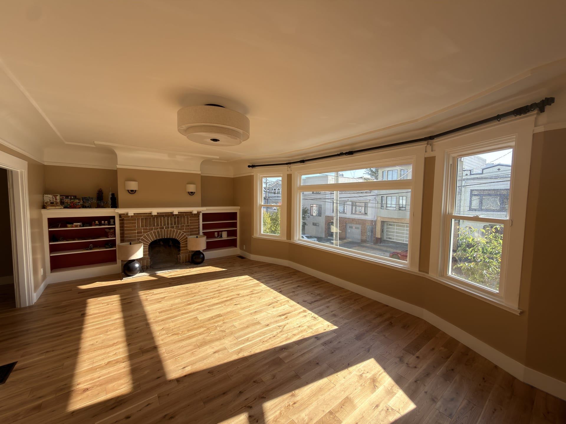Traditional living room with brick fireplace and bay windows