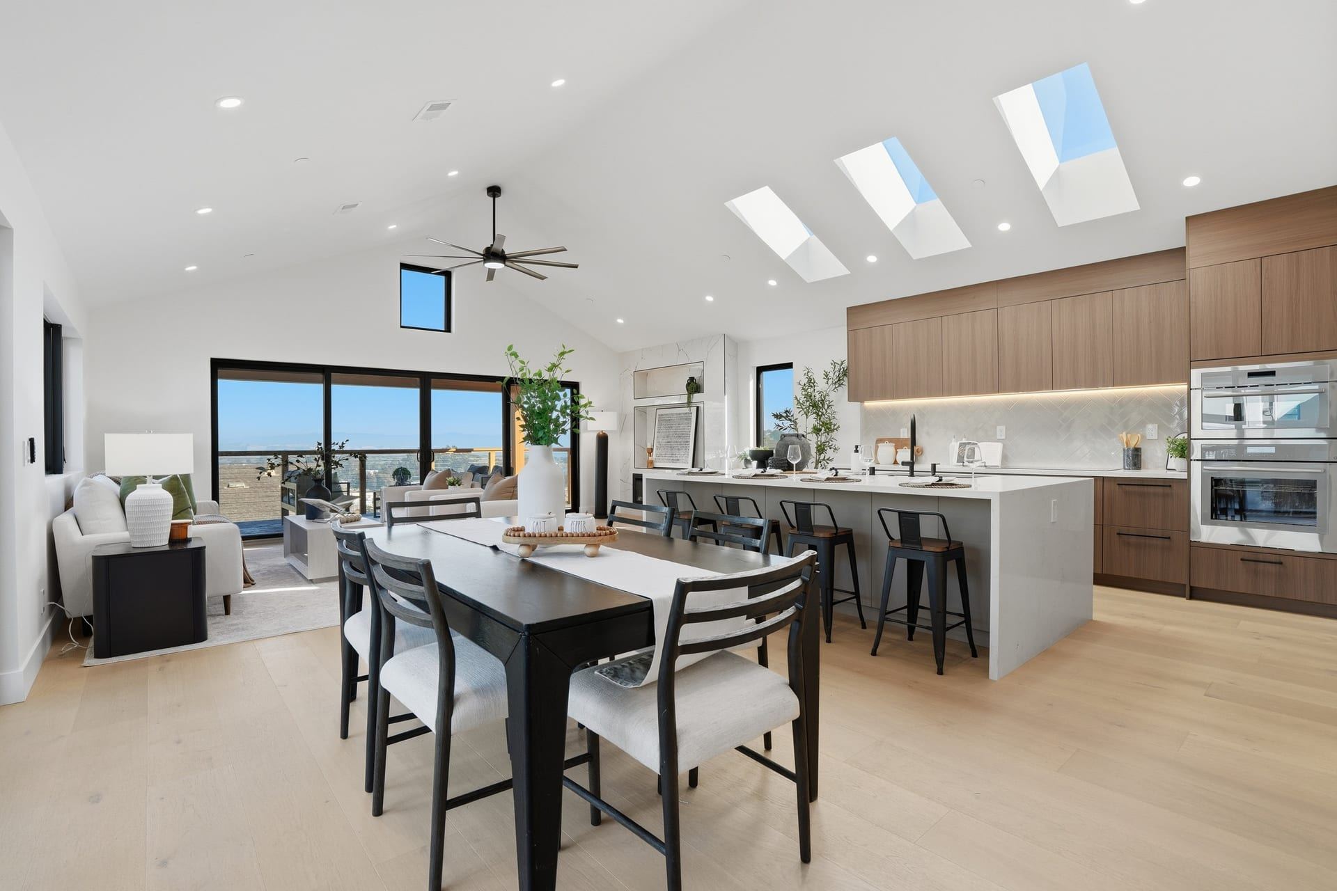 Open plan kitchen and living room with skylights and bay views brisbane