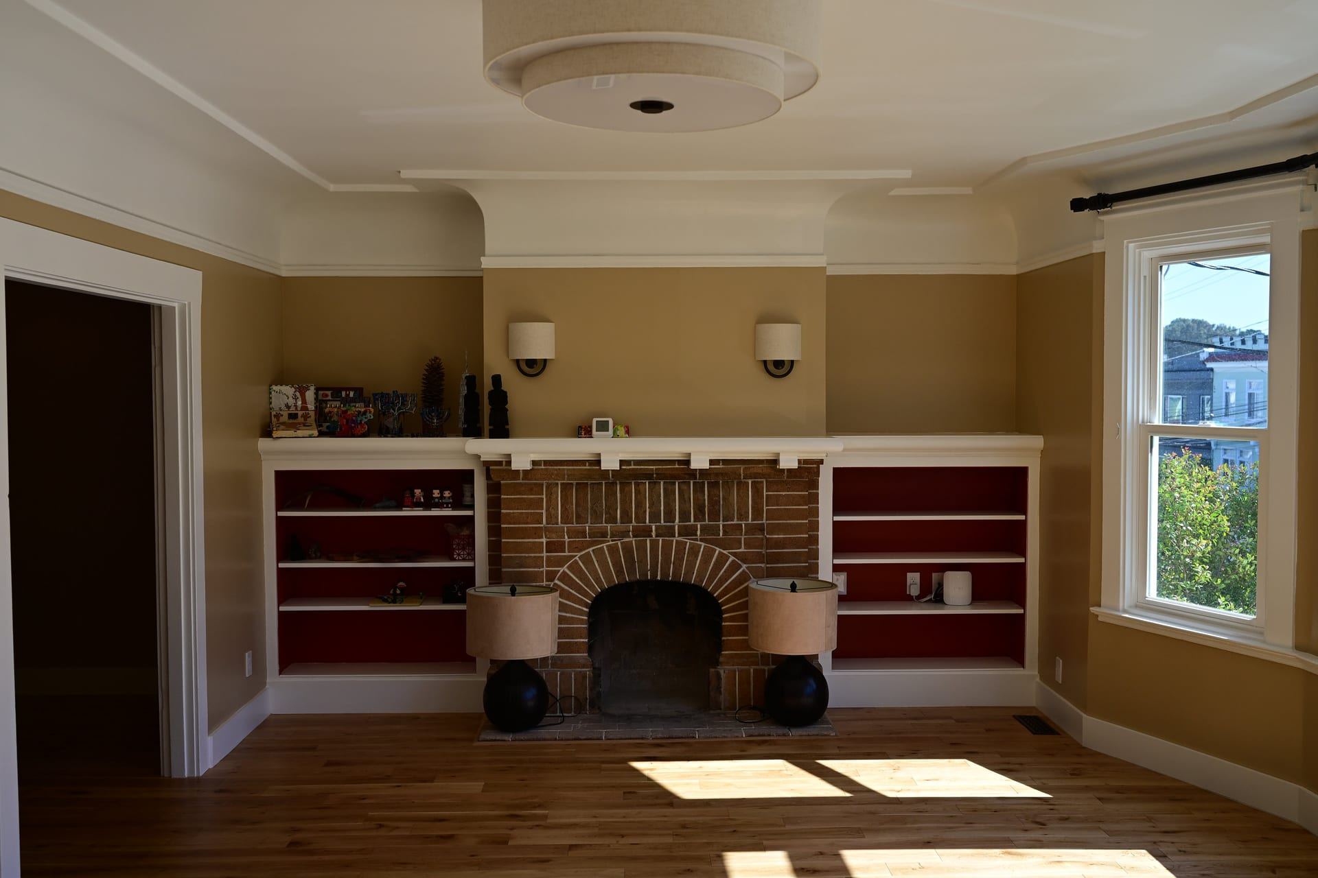 Brick fireplace with built in shelving and original architectural detail