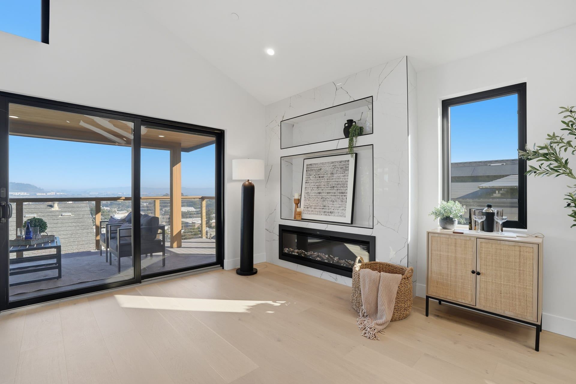 Contemporary fireplace wall with sliding glass doors and scenic view