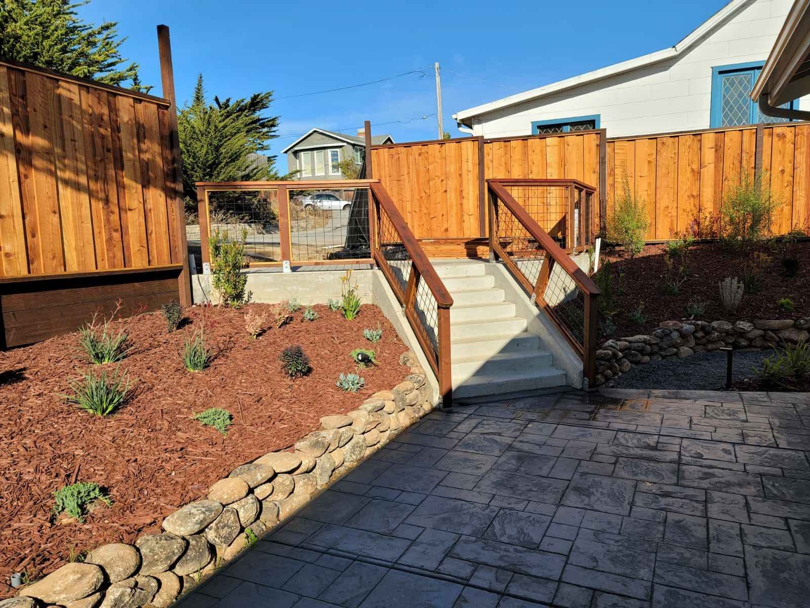 Backyard landscape renovation with tiered privacy fence san mateo