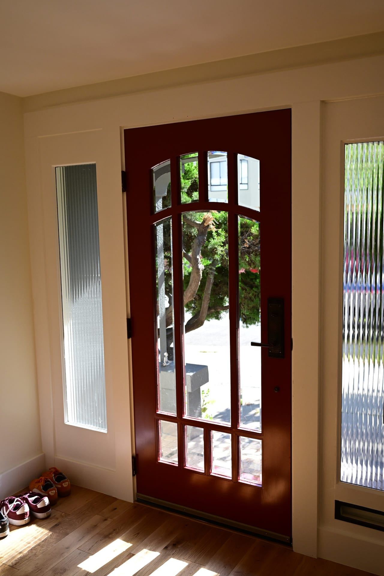 Traditional entry with multi lite wood door and textured glass
