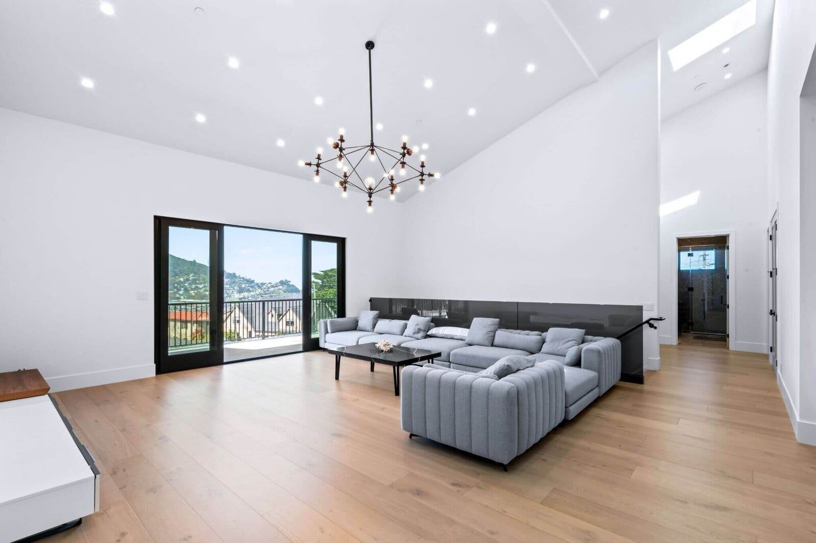 Vaulted family room with hillside views and