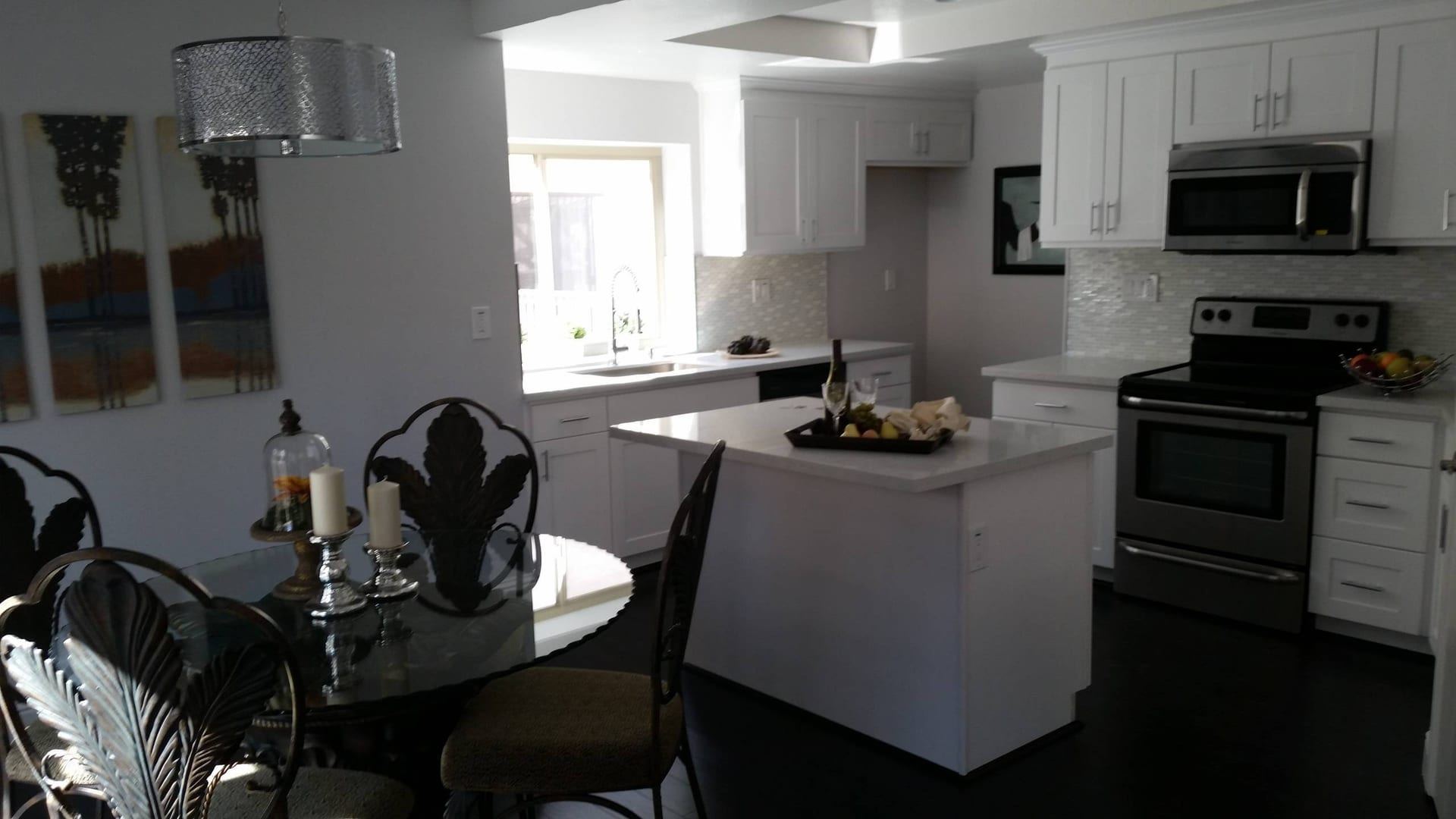 White kitchen with central island and adjacent