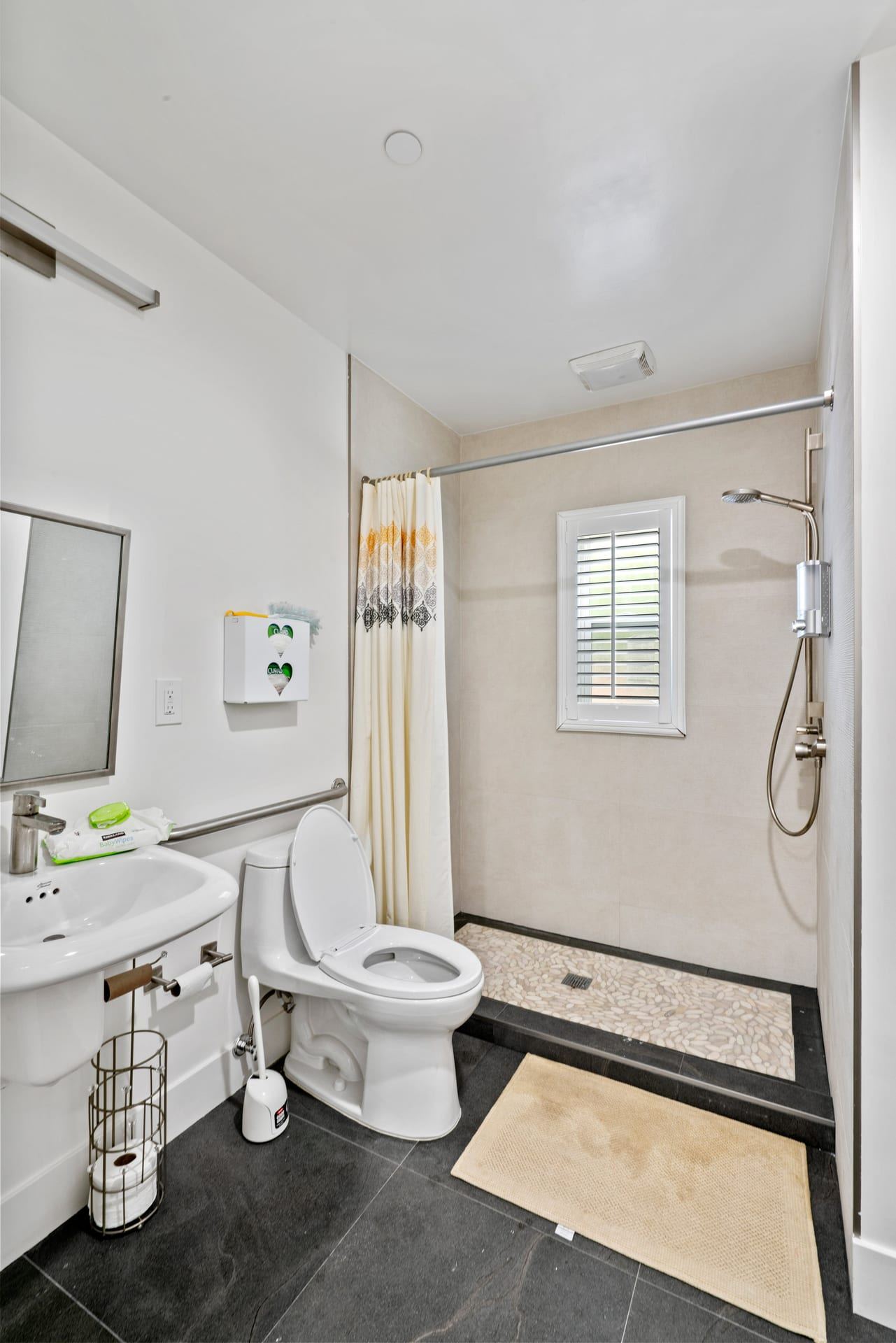 Accessible walk in shower with grab bars and handheld fixture novato