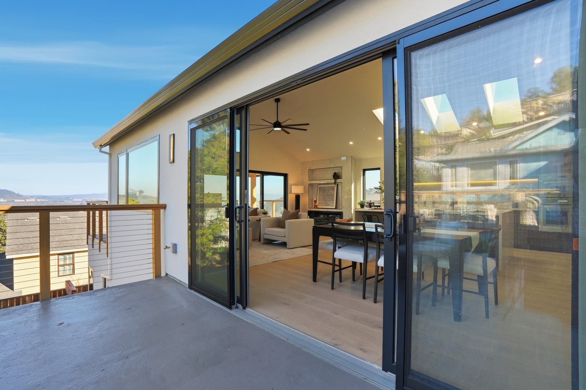 Indoor outdoor dining area with large sliding glass doors