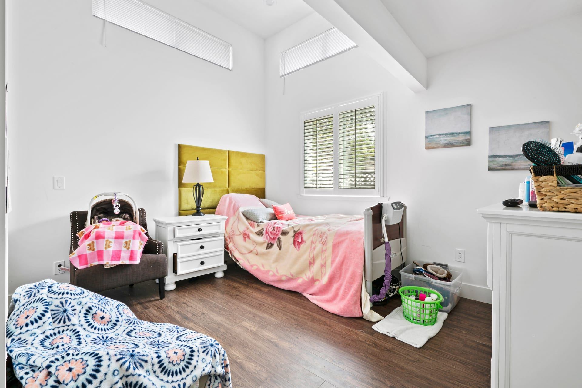 Bright accessible bedroom with vaulted ceiling and dark flooring novato