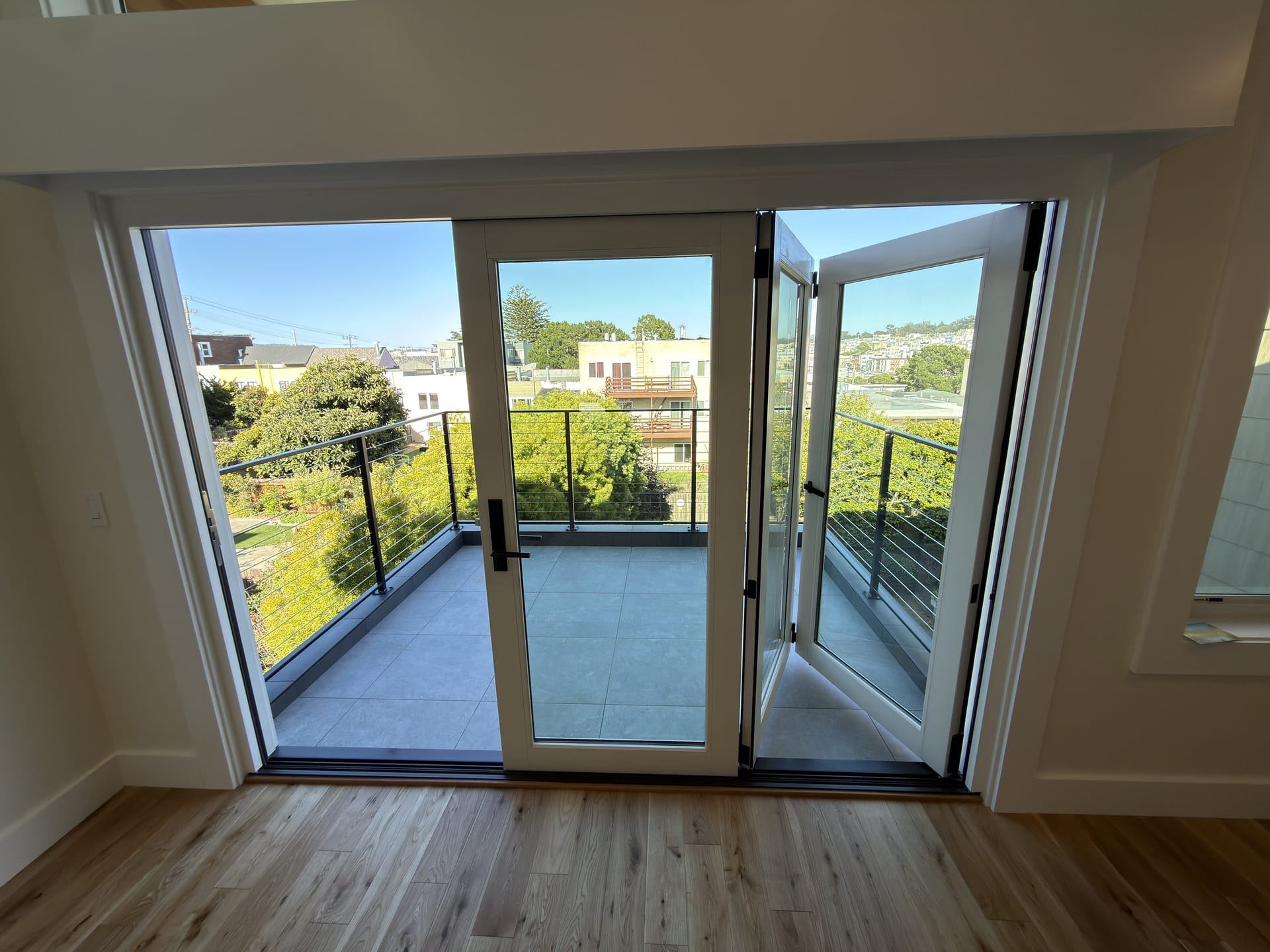 Bedroom deck access with black framed glass doors