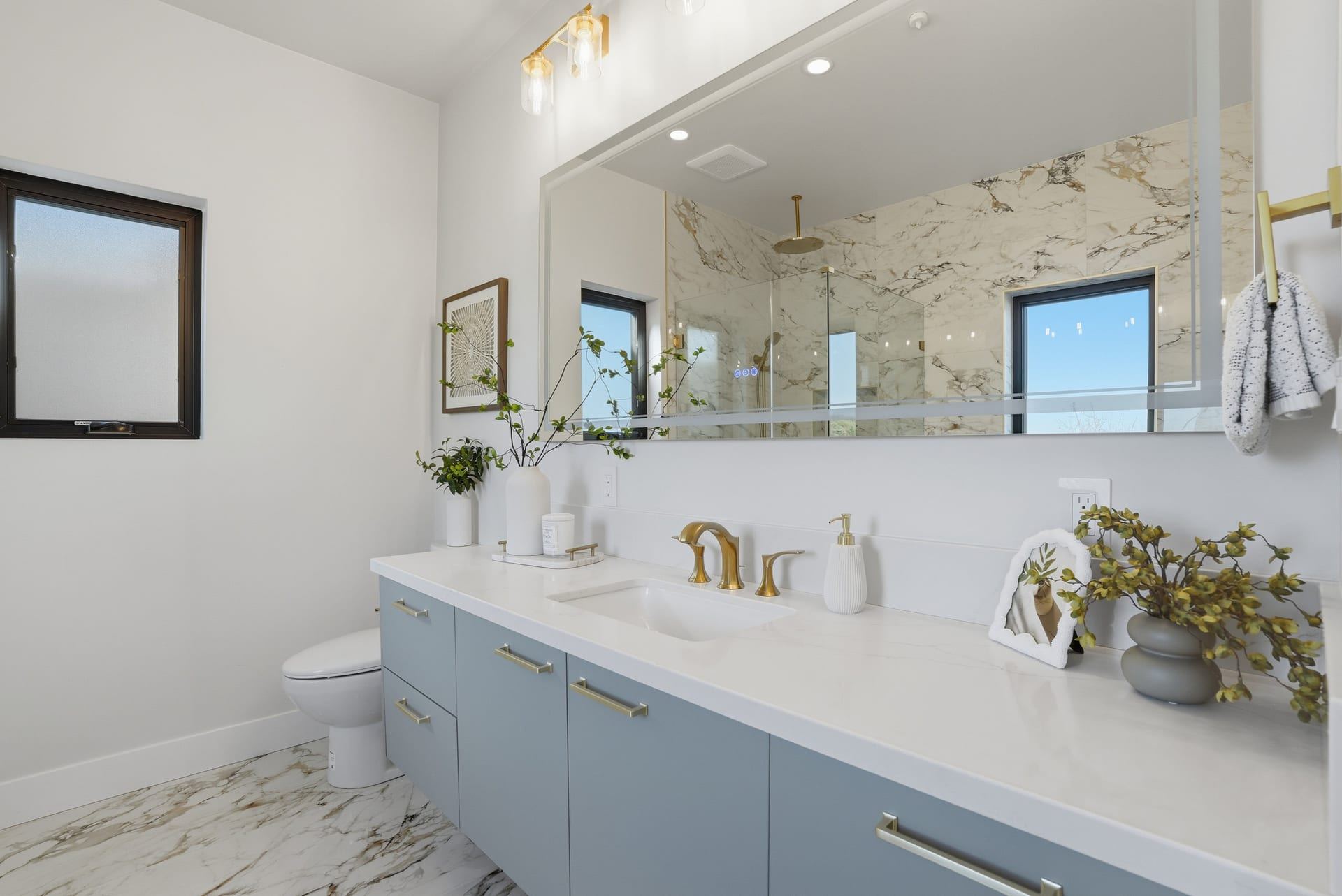 Spa bathroom with long double vanity and veined tile