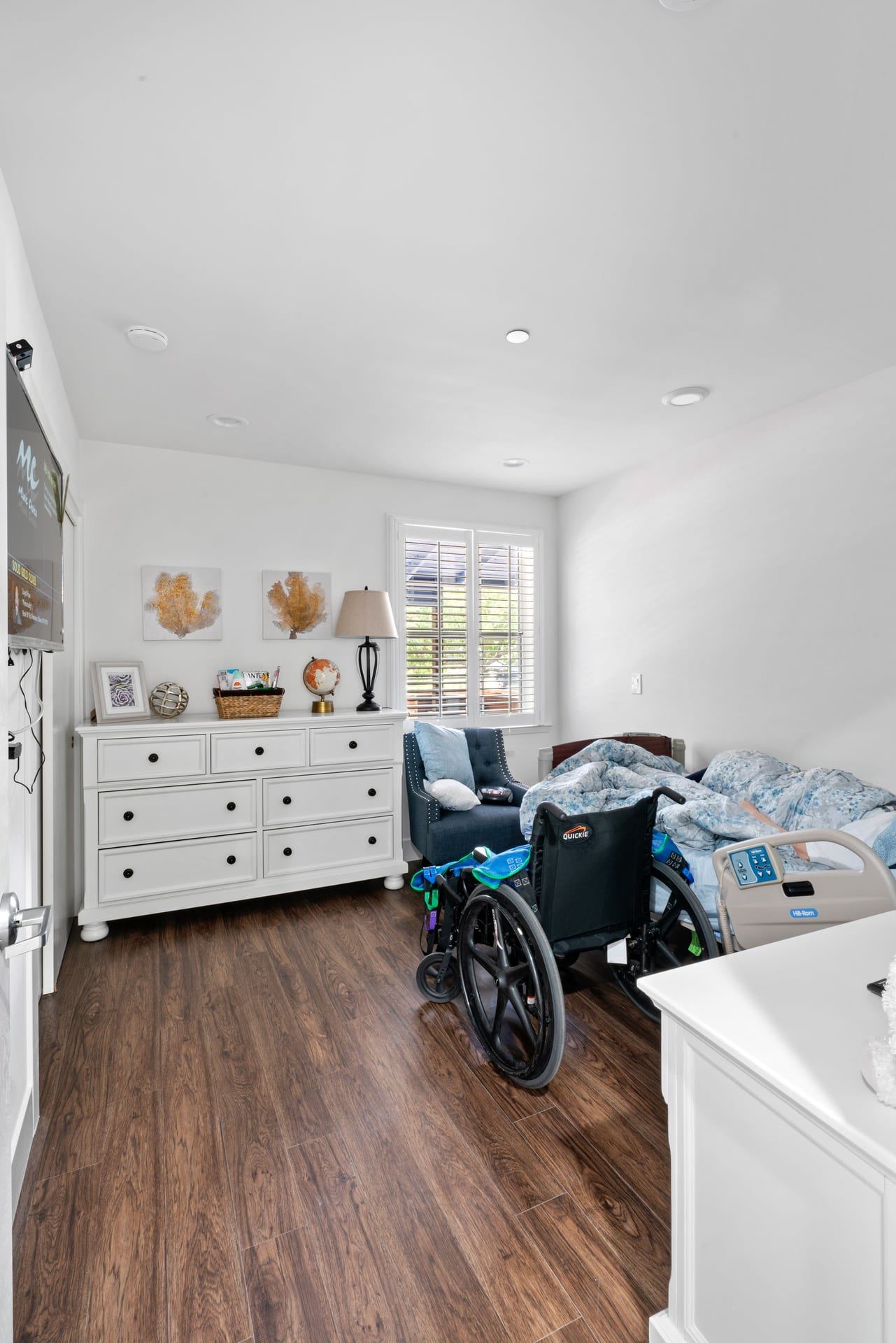 Accessible bedroom with wide clearances and dark wood look flooring novato