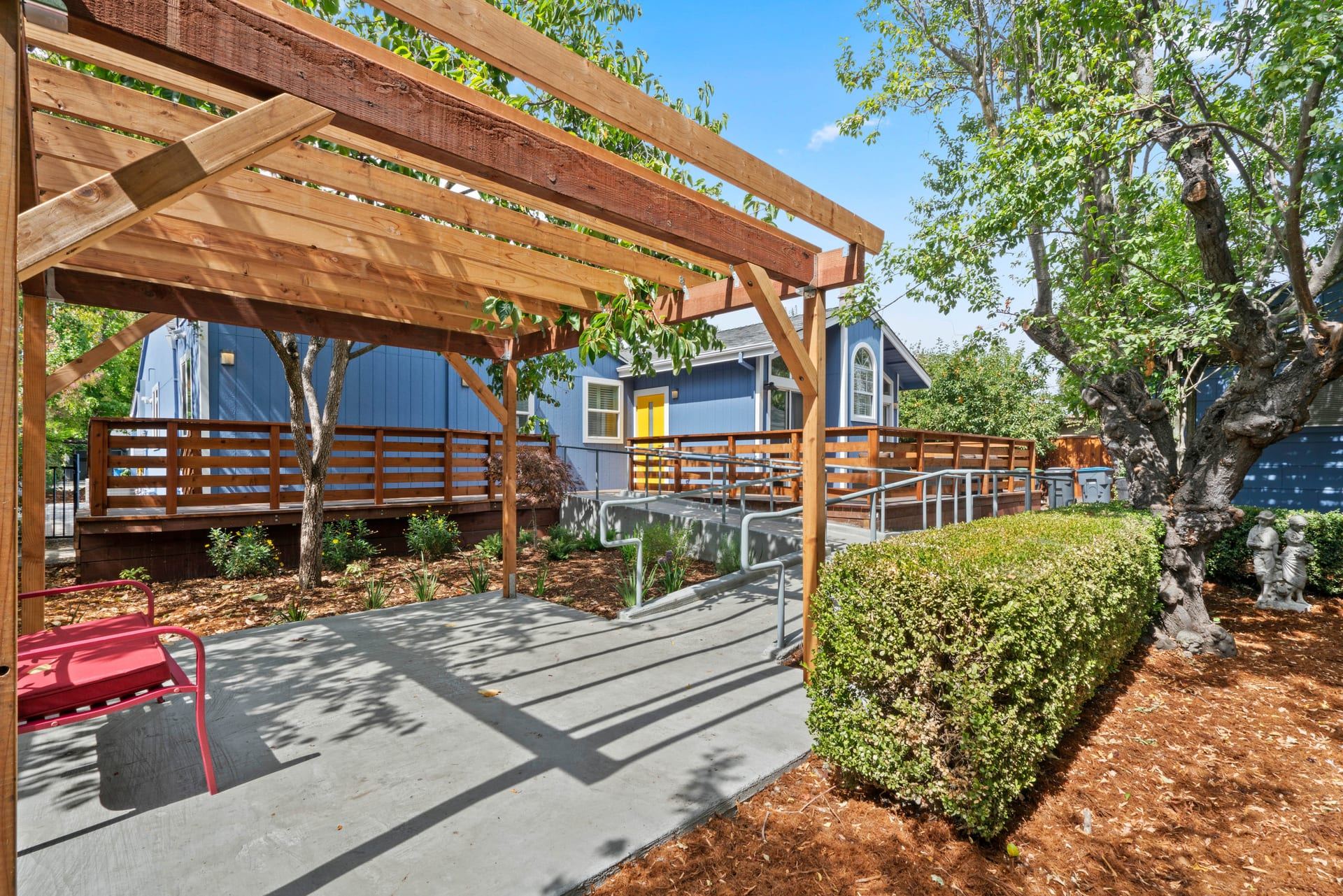 Accessible backyard patio with timber pergola and concrete ramp novato