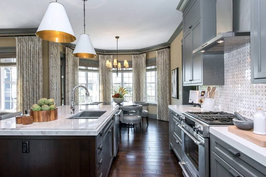 Transitional gray kitchen with island and bay window dining area