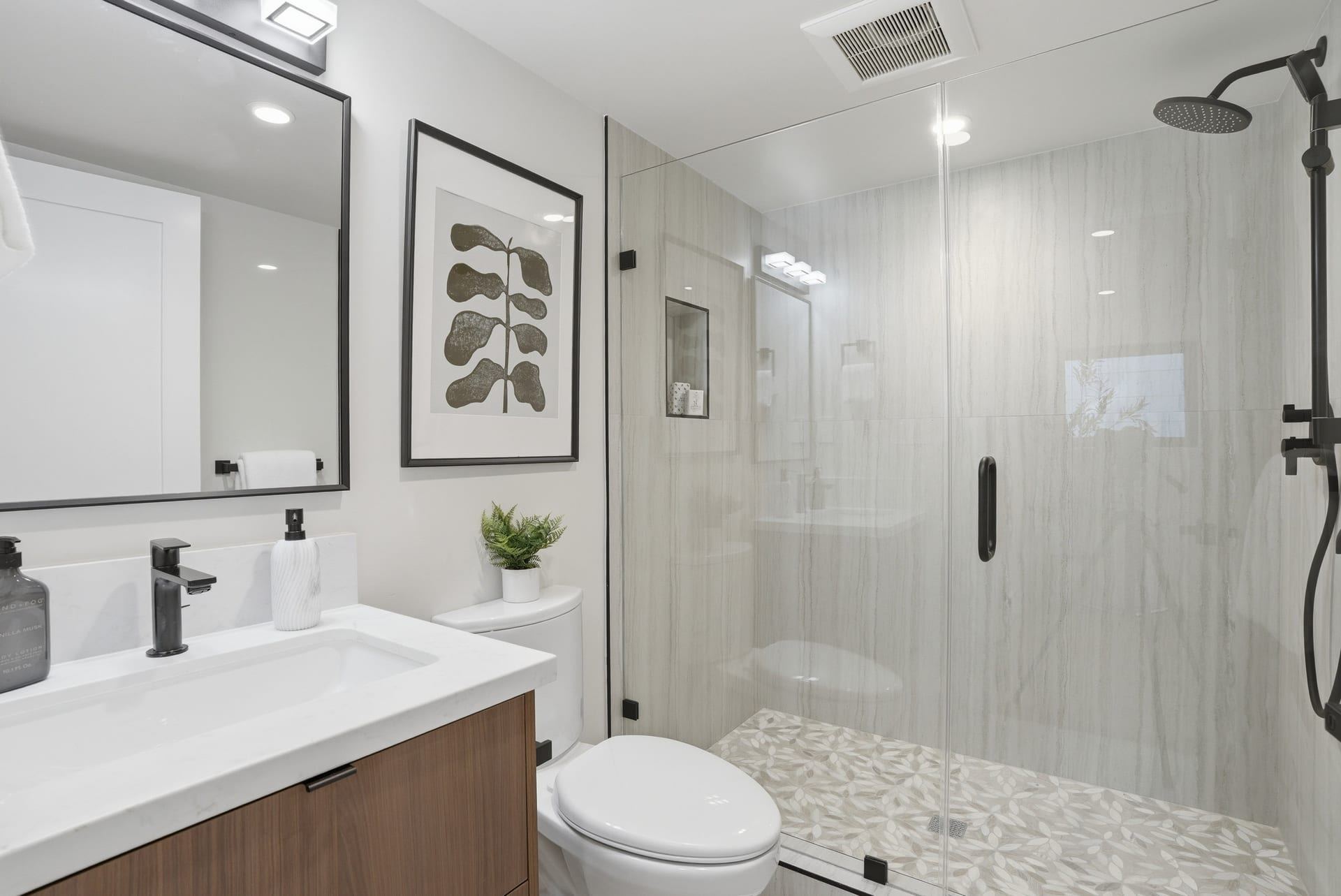 Compact adu bathroom with walk in shower and wood vanity