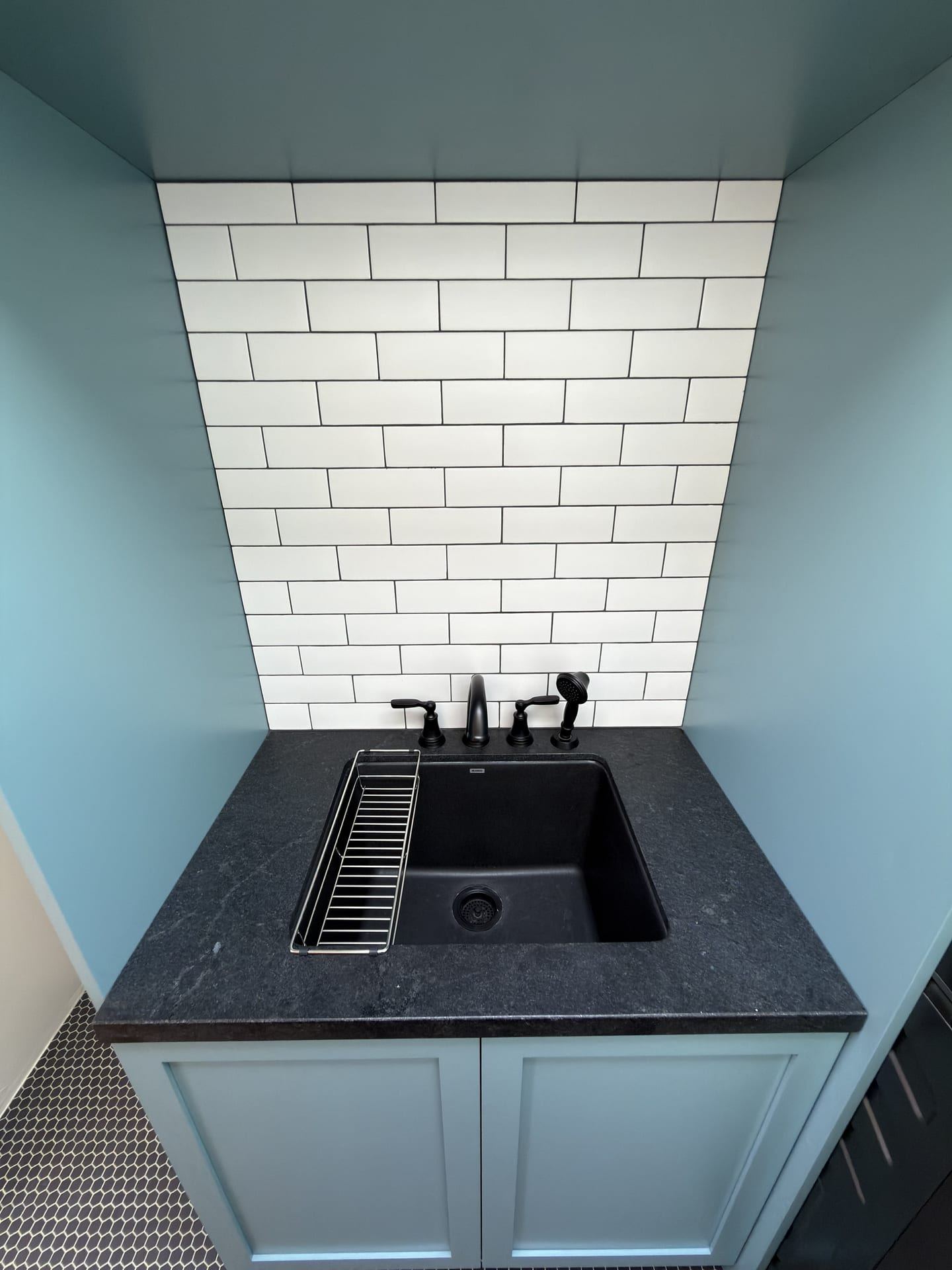 Compact laundry and utility area with built in sink
