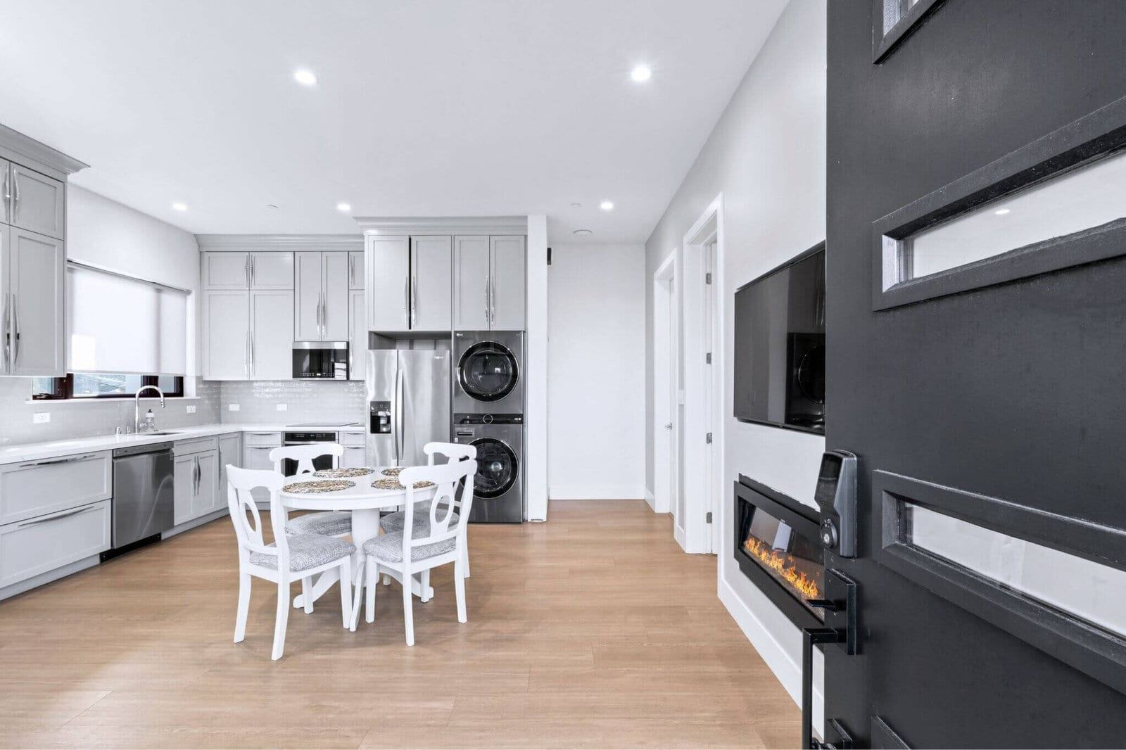 Modern adu kitchen and dining area with linear fireplace