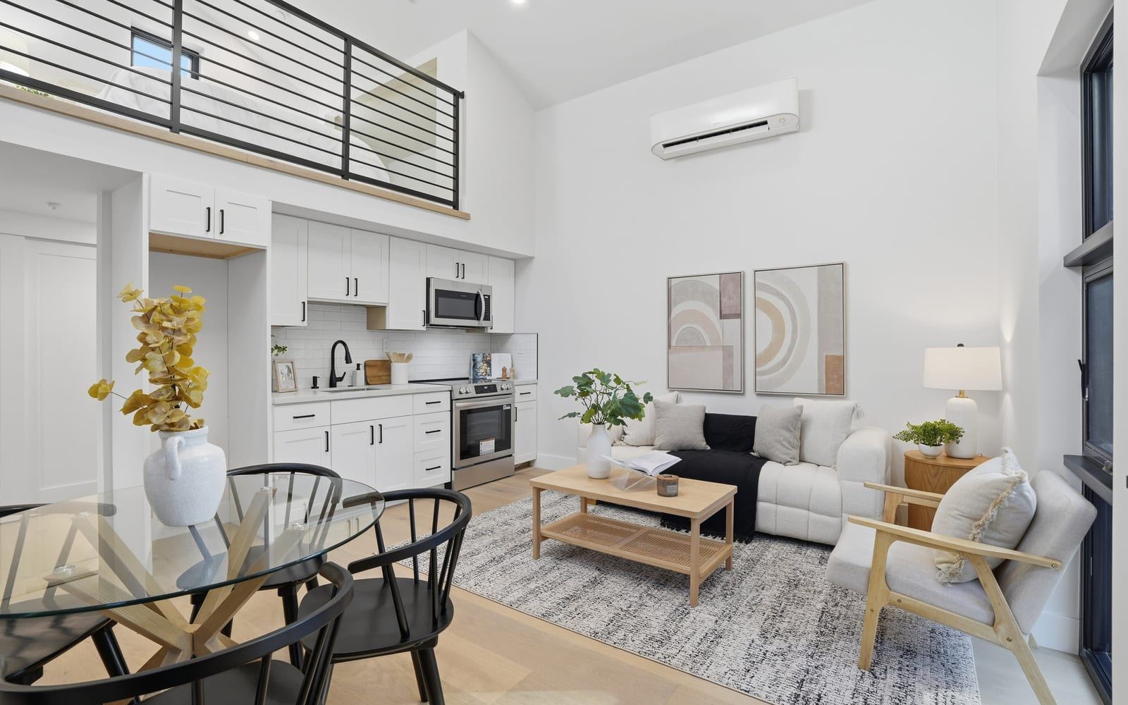 Open living space with a full kitchen and a double-height ceiling