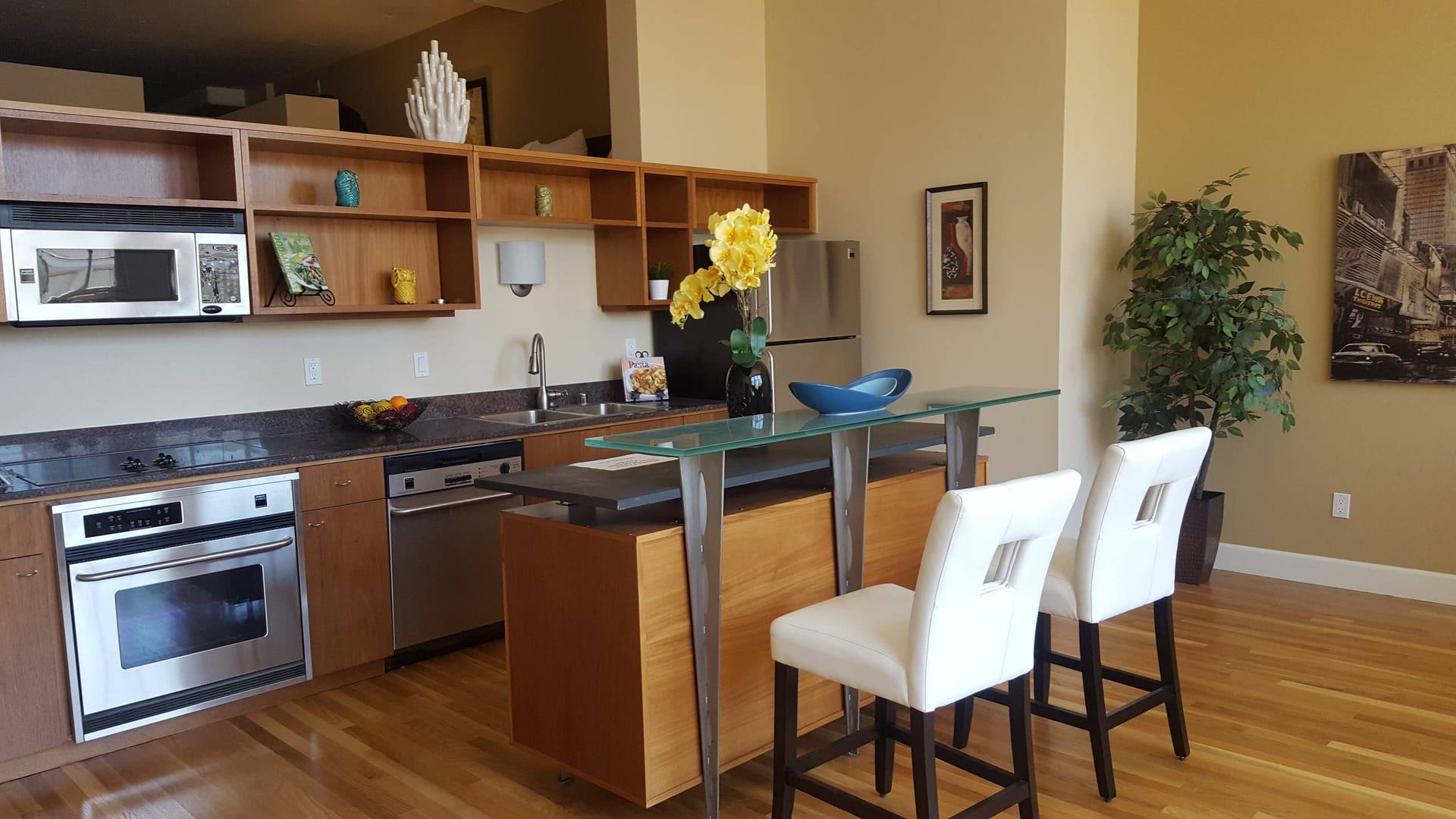 Loft kitchenette with glass breakfast bar and open shelving