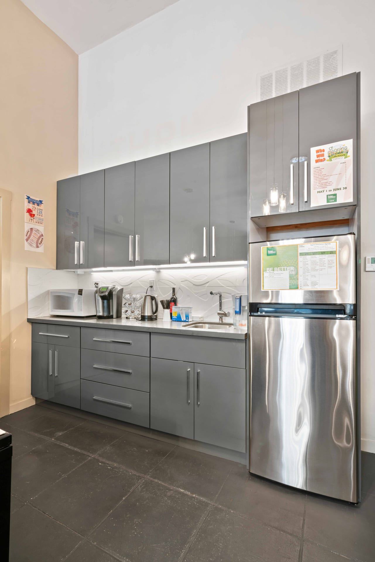 Gray office kitchenette with stainless steel appliances