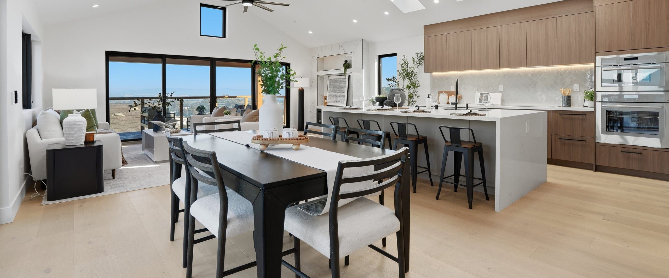 Open-plan kitchen and living room with skylights and Bay views