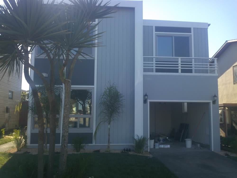 Contemporary gray two story home with balcony