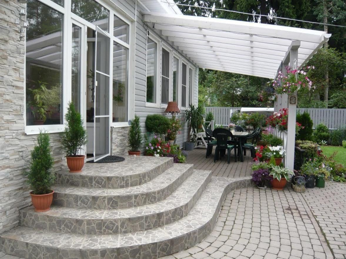 Paver patio with white pergola and curved stone steps oakland
