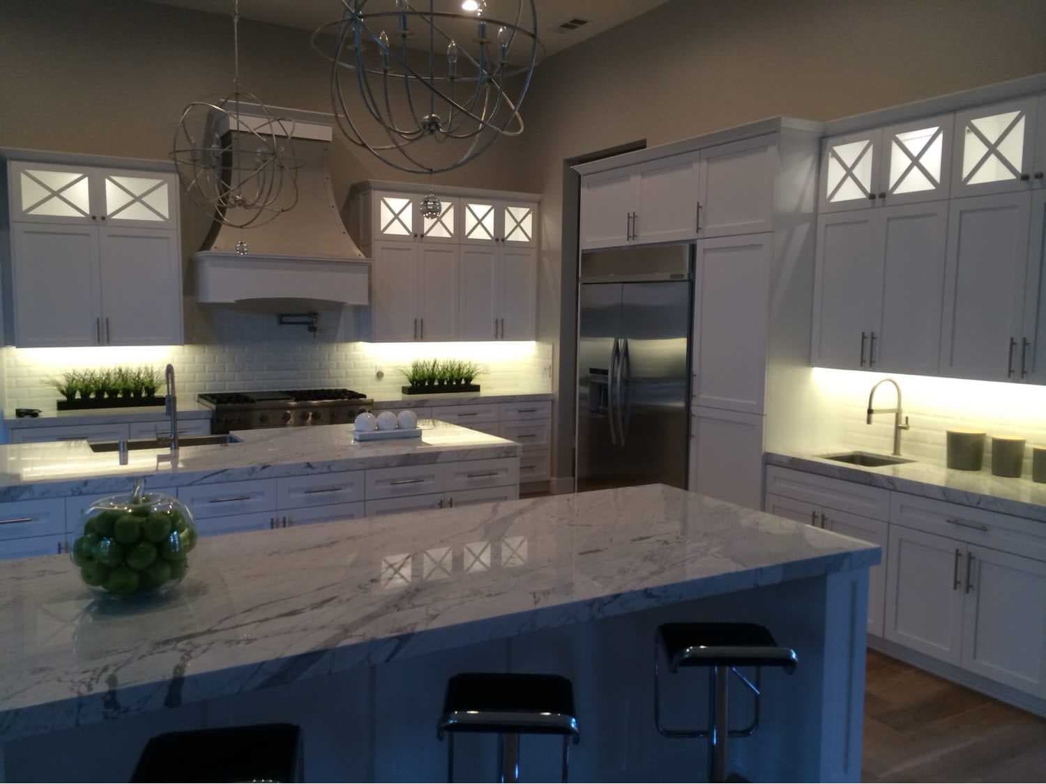 White kitchen with dual islands and marble look countertops san mateo