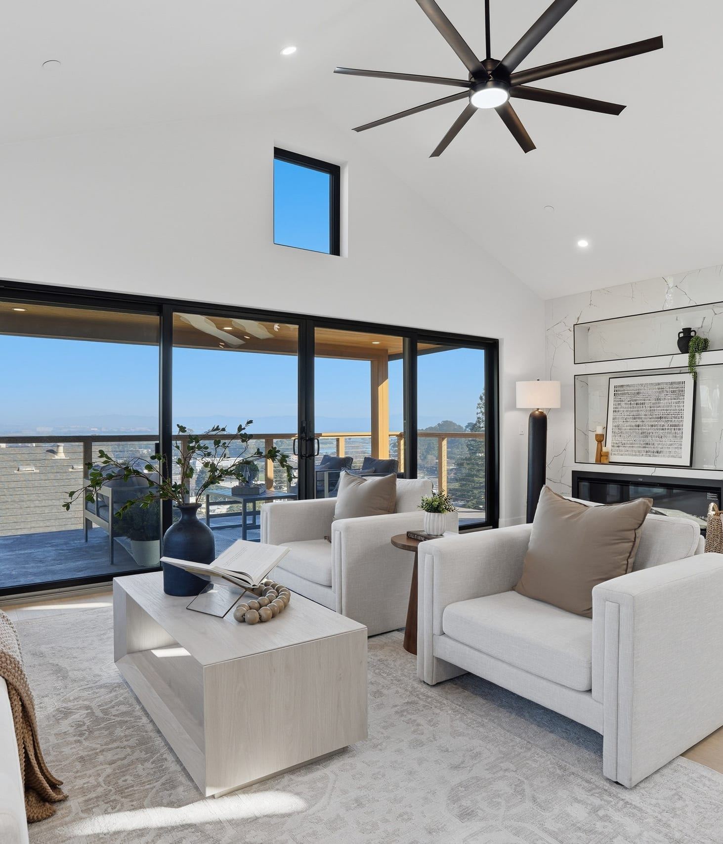 Vaulted living room with a linear fireplace and Bay views