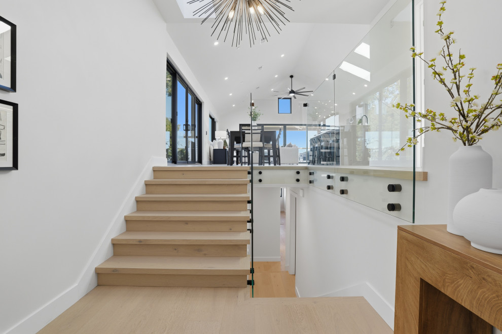 Modern Wood Staircase with Glass Railing and Open Living View