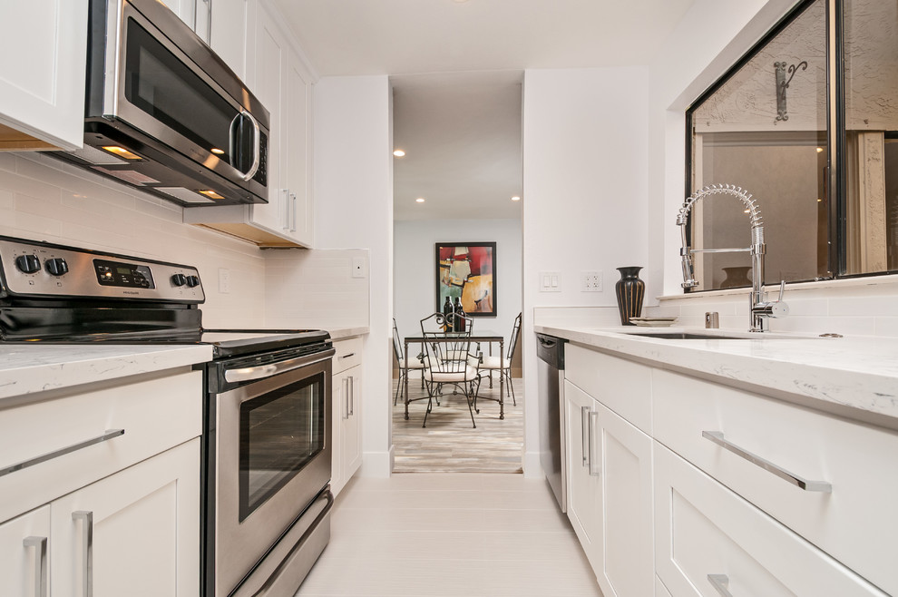 White Galley Kitchen with Long Countertop and Spring Faucet