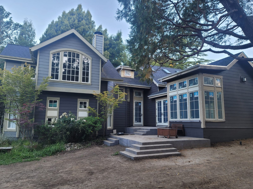 Dark Gray Home Exterior with New Windows and Concrete Patio