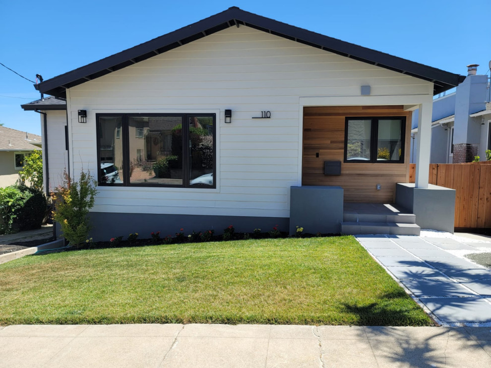 Modern White Bungalow Exterior with Wood Entry Accent