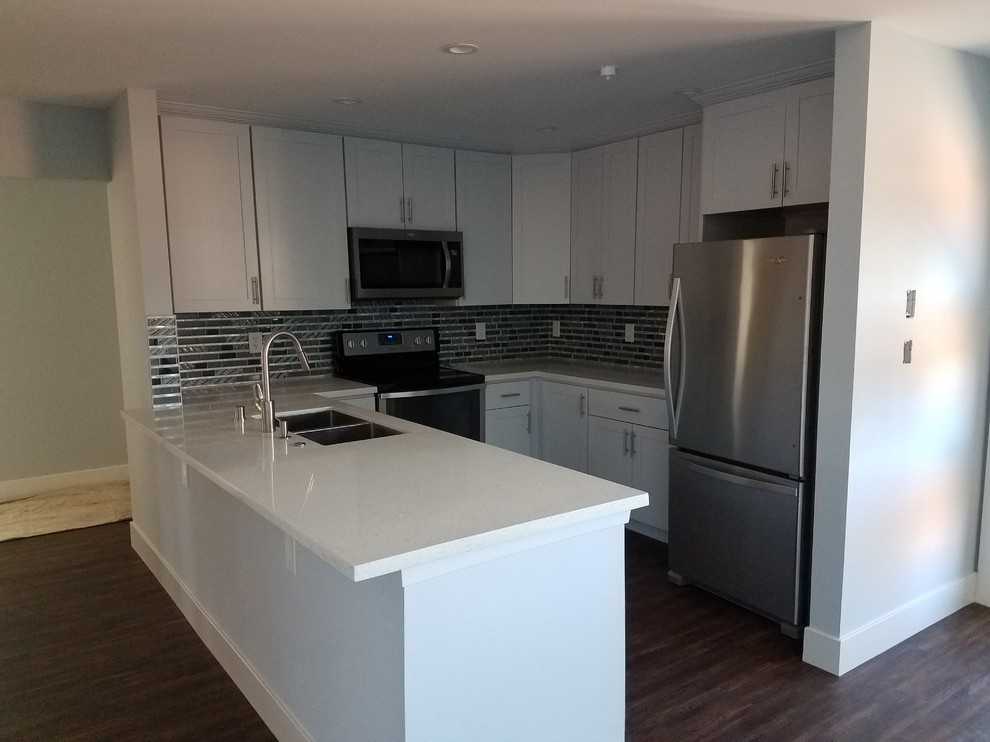 Compact White Kitchen with Peninsula and Mosaic Backsplash