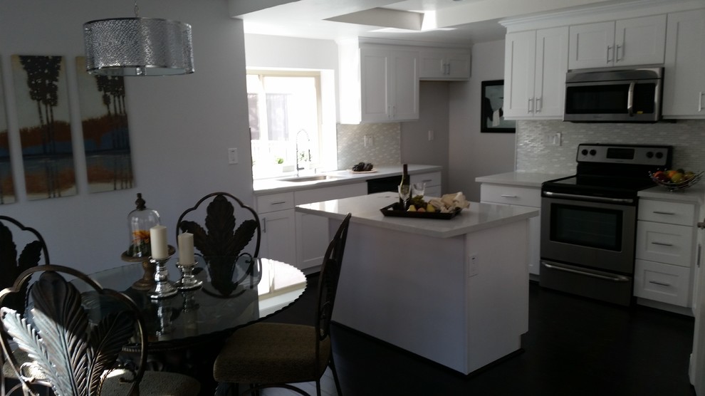 White Kitchen with Central Island and Adjacent Dining Room