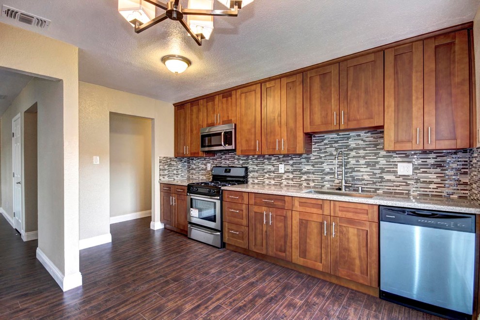 Warm Wood Kitchen with Full-Height Cabinetry and Mosaic Backsplash
