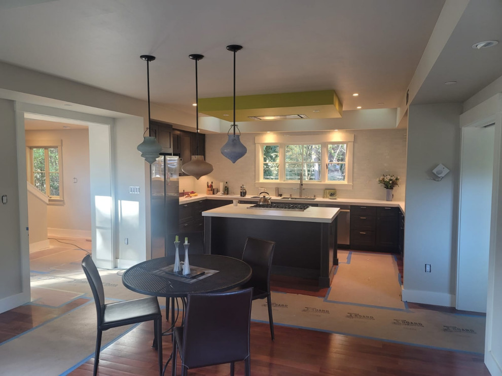 Dark Wood Kitchen with Island Cooktop and Sculptural Pendants